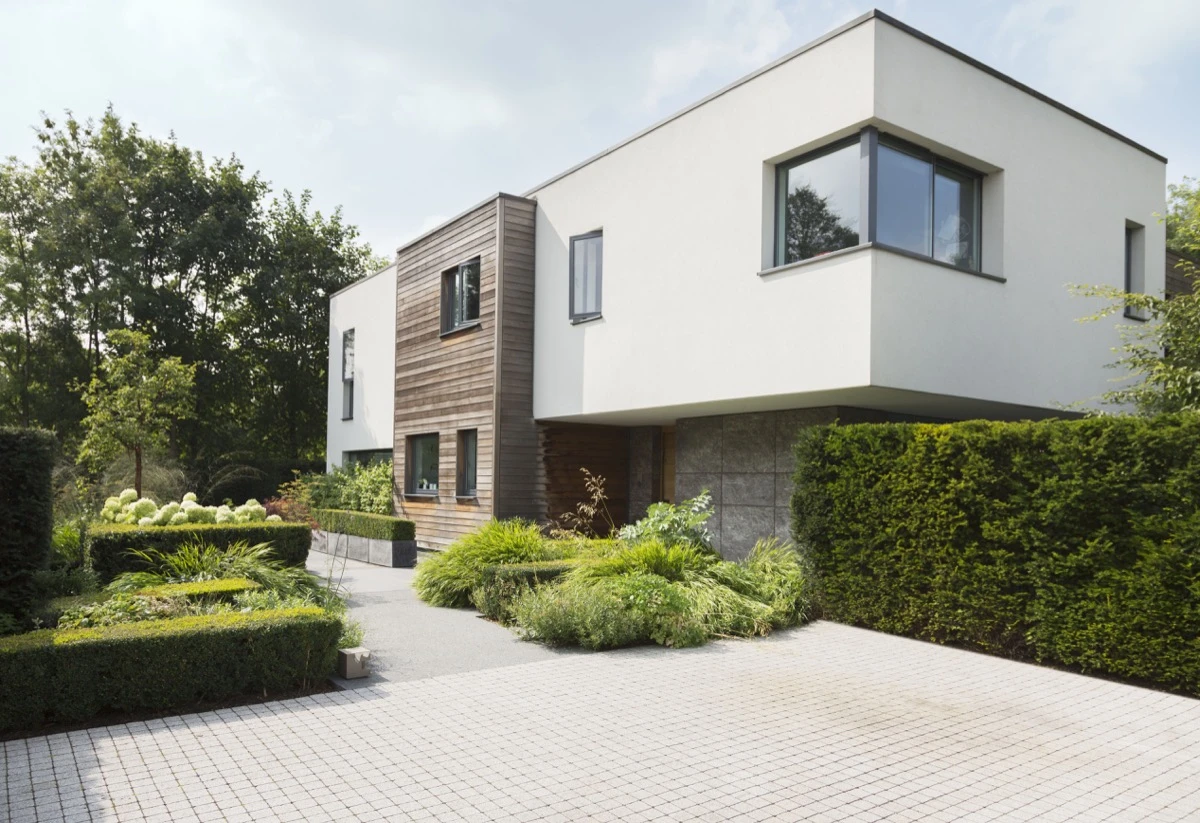 Slate Home Improvements brand photography of a contemporary home surrounded by landscaped gardens.